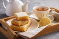 Homemade baked lemon bars and cup of tea. Royalty Free Stock Photo