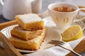 Homemade baked lemon bars and cup of tea. Royalty Free Stock Photo