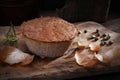 Homemade, baked meat pate, close-up. Rustic composition with a meat product on a wood chopping board.