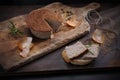 Homemade, baked meat pate. A rustic composition with a meat product on a wooden chopping board.