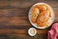 Homemade baked pies or patties stuffed with cabbage on wooden background. Top view Royalty Free Stock Photo