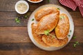 Homemade baked pies or patties stuffed with cabbage on wooden background. Top view Royalty Free Stock Photo