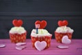 Cupcakes with pink background and love heart shapes