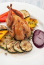 Homemade baked quails with grilled zucchini