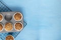 Homemade baking concept - fresh baked muffins on cooling rack, minimal picture, bright blue background, background, top view, copy