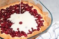 Homemade baking. Cooking sweet cranberry pie. Pouring cream Royalty Free Stock Photo