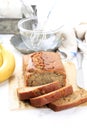 Homemade Banana Loaf Cake Bread Sliced on a Table Close Up. Vertical, White Rustic Style Royalty Free Stock Photo