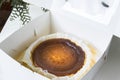 Homemade Basque Burnt Cheesecake in take away box. Royalty Free Stock Photo