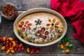 Homemade and beautiful italian focaccia in round baking bowl. Decoration that looks like flowers in garden is made of Royalty Free Stock Photo