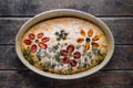 Homemade delicious, italian focaccia in round baking bowl on wooden table. Decoration that looks like flowers in Royalty Free Stock Photo