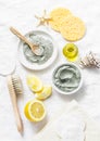 Homemade beauty facial mask. Clay, lemon, oil, facial brush - beauty products ingredients on light background