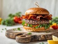 Homemade beef burger with crispy bacon and vegetables on rustic serving board Royalty Free Stock Photo