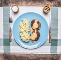 Homemade beef burgers with sauce and mashed potatoes with herbs and mushrooms on a blue plate vintage knife fork, salt an