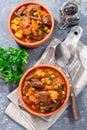 Homemade beef stew with potato, green beans, carrot, peas and corn, in ceramic bowl, vertical, top Royalty Free Stock Photo