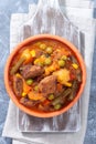 Homemade beef stew with potato, green beans, carrot, peas and corn, in ceramic bowl, vertical, top Royalty Free Stock Photo