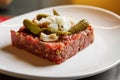 Homemade beef tartare on a white plate. Royalty Free Stock Photo
