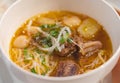 Homemade beef vegetable soup in a white bowl. Delicious noodles soup in a bowl with bread. Meat soup with vegetables Royalty Free Stock Photo