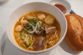 Homemade beef vegetable soup in a white bowl. Delicious noodles soup in a bowl with bread. Meat soup with vegetables Royalty Free Stock Photo