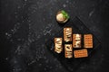 Homemade Belgian waffles with banana and ice cream on a cooling rack. Black stone grunge background. Top view