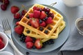 Homemade belgian waffles with berries on gray table. Healthy breakfast concept Royalty Free Stock Photo