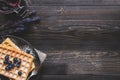 Homemade belgian waffles with blueberries on the dark wooden tab Royalty Free Stock Photo