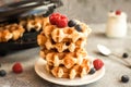 Homemade Belgian waffles with forest fruits, blueberries, raspberries and yogurt. Royalty Free Stock Photo