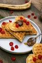 Homemade Belgian waffles heart shaped on plate with colorful red sweet cherry berries, banana, and boiled condensed milk, dessert Royalty Free Stock Photo