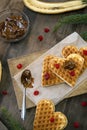 Homemade Belgian waffles heart shaped with red sweet cherry berries,banana,boiled condensed milk. Christmas new year Royalty Free Stock Photo