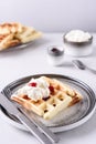 Homemade Belgian Waffles served with whipped cream Chantilly and berry jam