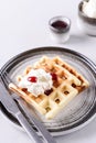 Homemade Belgian Waffles served with whipped cream Chantilly and berry jam