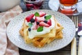 Homemade belgian waffles with yogurt, strawberry and blueberry, breakfast time Royalty Free Stock Photo