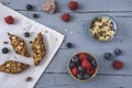 Homemade berry granola bars with blueberries and raspberries on light blue wooden table Royalty Free Stock Photo