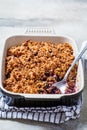 Homemade berry oat crumble pie in backing dish. Comfort food concept Royalty Free Stock Photo