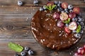 Homemade berry pie close up ,  chocolate cake with fresh berries red grapes and blueberries, mint on a wooden Royalty Free Stock Photo