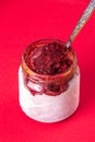 Homemade bilberry bluebrry fruit sorbet granita in hoarfrost glass jar on red background. summer dessert, sweet snack Royalty Free Stock Photo