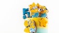 Homemade birthday yellow cake decorated with ginerbread cookies in the shape of minions. Characters of the animated movie ``