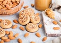 Homemade biscuit cookies with almond nuts and peanut butter on marble board on white kitchen table background. Almonds in wooden Royalty Free Stock Photo