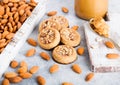 Homemade biscuit cookies with almond nuts and peanut butter on marble board on white kitchen table background. Almonds in wooden Royalty Free Stock Photo