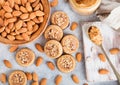 Homemade biscuit cookies with almond nuts and peanut butter on marble board on white kitchen table background. Almonds in wooden Royalty Free Stock Photo