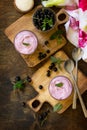 Homemade black currant mousse on rustic wooden table. Delicious summer dessert.