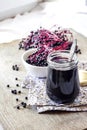 Homemade black elderberry syrup in glass jar