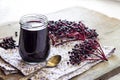 Homemade black elderberry syrup in glass jar