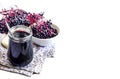 Homemade black elderberry syrup in glass jar with copy space