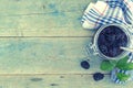 Homemade blackberries jam in a glass jar over rustic wooden table. Healthy food concept. Organic berries. Top view