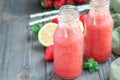 Homemade blended lemonade with fresh strawberry, lemon, ice and mint in bottle, horizontal, copy space