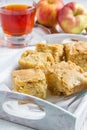 Homemade blondie brownies apple cake, square slices in wooden tray