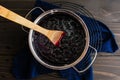 Homemade Blueberry Compote in a Small Pot with a Wooden Spoon