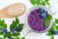 Homemade blueberry face and body sugar/salt scrub in a glass jar. DIY cosmetics for natural skin and hair care. Royalty Free Stock Photo