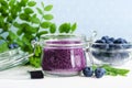 Homemade blueberry face and body sugar scrub/bath salts/foot soak in a glass jar. DIY cosmetics for natural skin care. Copy space. Royalty Free Stock Photo