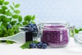 Homemade blueberry face and body sugar scrub/bath salts/foot soak in a glass jar. DIY cosmetics for natural skin care. Copy space. Royalty Free Stock Photo